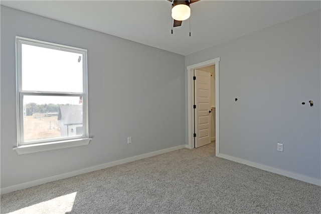 empty room with ceiling fan and carpet flooring