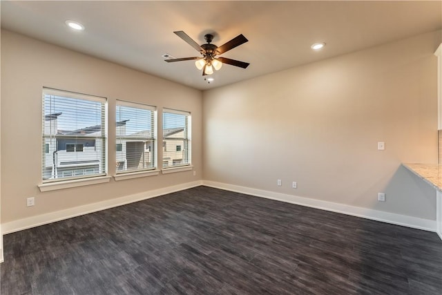 unfurnished room with dark wood-type flooring and ceiling fan