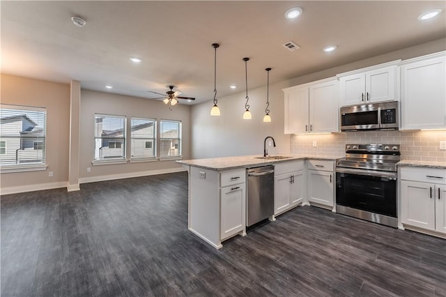 kitchen with white cabinetry, stainless steel appliances, kitchen peninsula, and hanging light fixtures