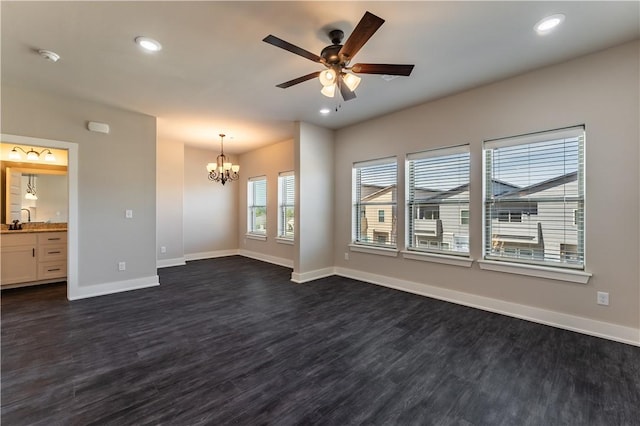 unfurnished room with sink, ceiling fan with notable chandelier, and dark hardwood / wood-style flooring