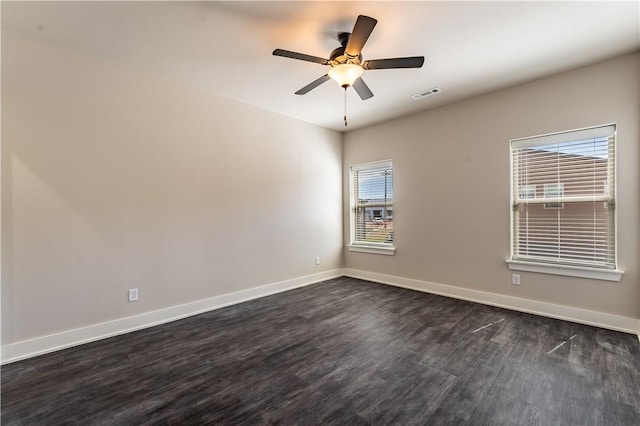 spare room with dark hardwood / wood-style floors and ceiling fan