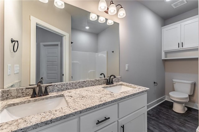 bathroom with vanity, hardwood / wood-style flooring, toilet, and walk in shower