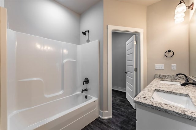 bathroom with shower / bathtub combination, vanity, and hardwood / wood-style floors