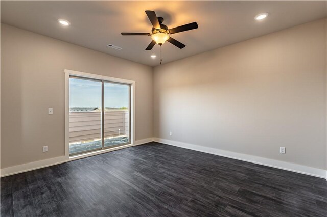 empty room with dark wood-type flooring and ceiling fan