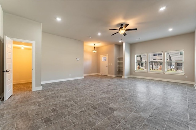 unfurnished living room with ceiling fan