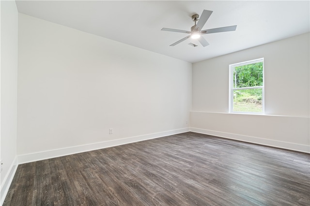 empty room with dark hardwood / wood-style flooring and ceiling fan