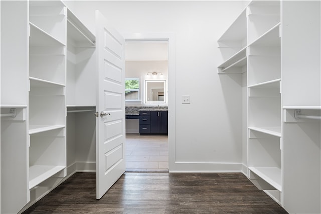 spacious closet with dark hardwood / wood-style floors