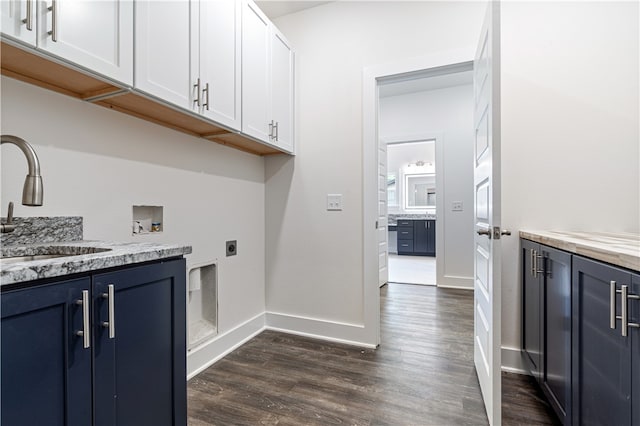 laundry area featuring electric dryer hookup, cabinets, sink, hookup for a washing machine, and dark hardwood / wood-style floors