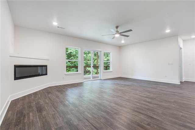 unfurnished living room featuring dark hardwood / wood-style floors and ceiling fan