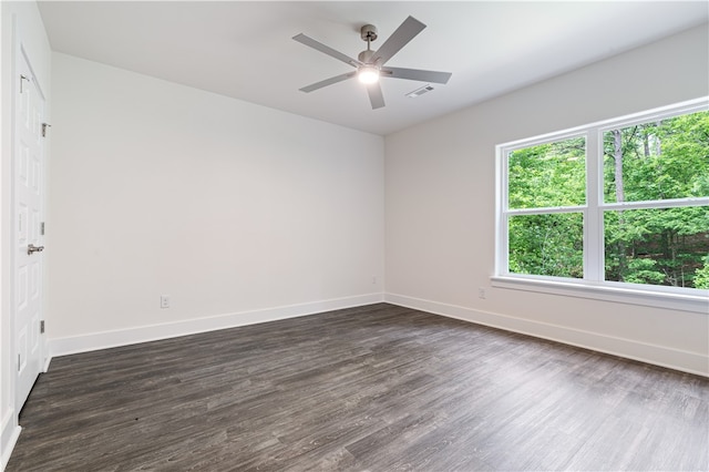 unfurnished room featuring dark hardwood / wood-style floors and ceiling fan