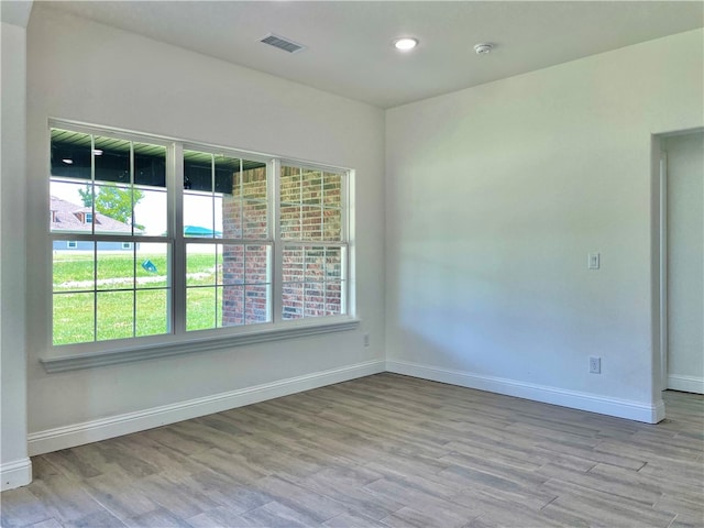 unfurnished room with light hardwood / wood-style flooring