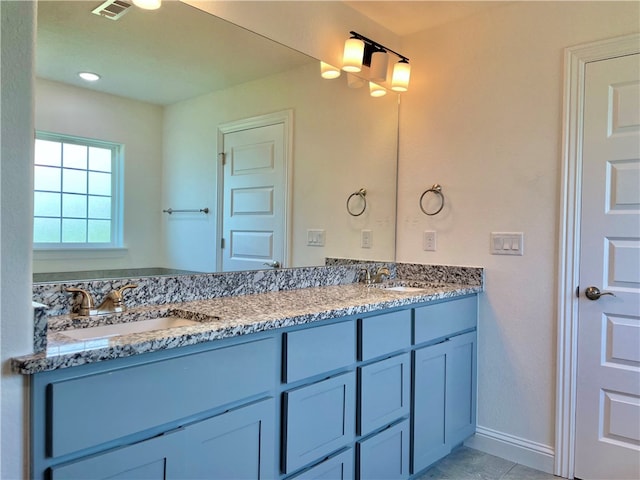 bathroom featuring vanity with extensive cabinet space and double sink