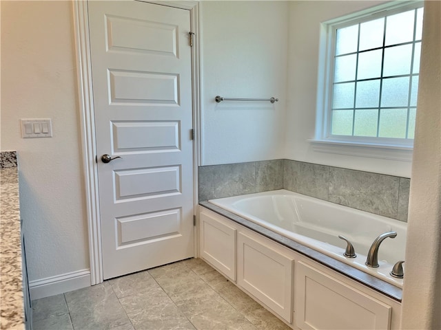 bathroom featuring tile flooring and a bath to relax in