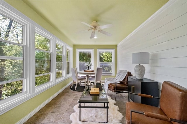 sunroom featuring ceiling fan