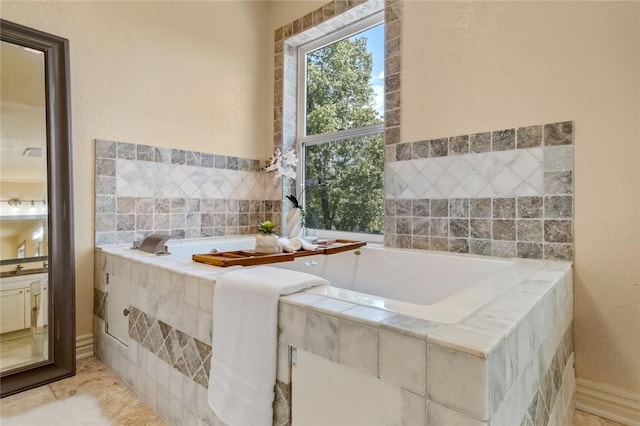 bathroom with a relaxing tiled tub