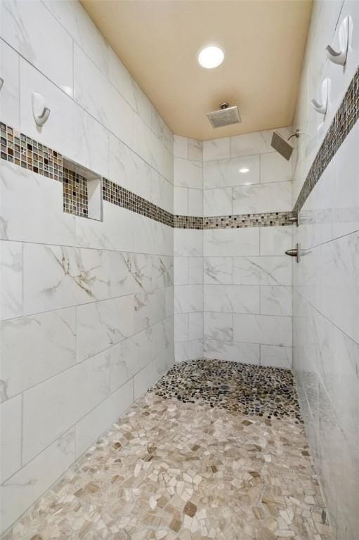 bathroom with a tile shower