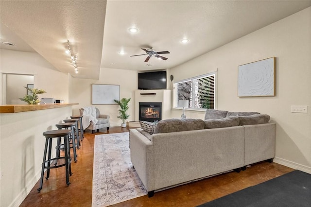 living room featuring rail lighting and ceiling fan