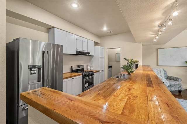 kitchen with white cabinetry, sink, wooden counters, and appliances with stainless steel finishes