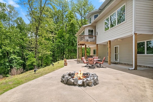 view of patio featuring a fire pit and a balcony