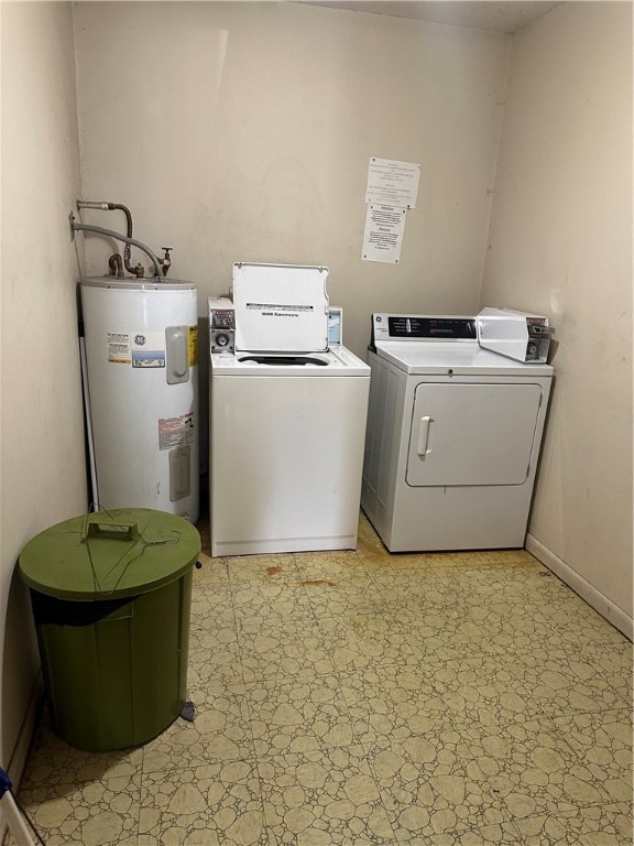 washroom with washer and dryer, electric water heater, and light tile floors