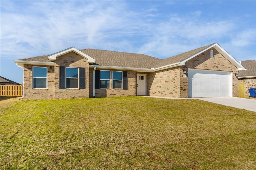 ranch-style house with a front lawn and a garage