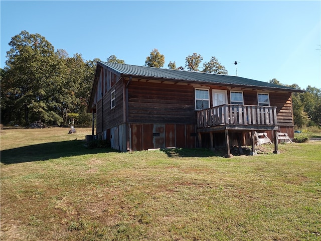 back of house featuring a yard and a wooden deck