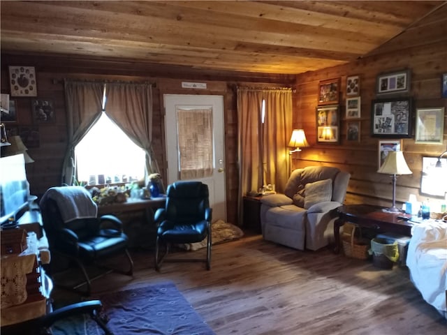 sitting room with wooden walls, lofted ceiling, wood ceiling, and hardwood / wood-style floors