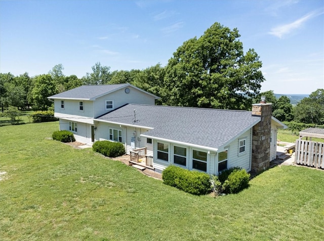 back of house with a lawn