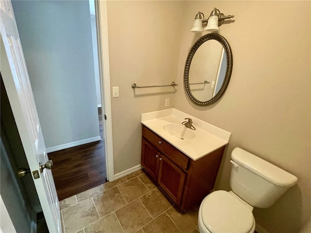 bathroom featuring vanity, hardwood / wood-style floors, and toilet