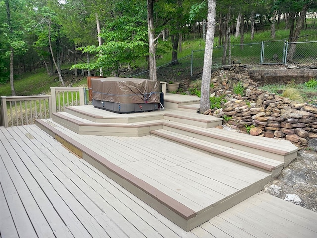 wooden terrace featuring a hot tub