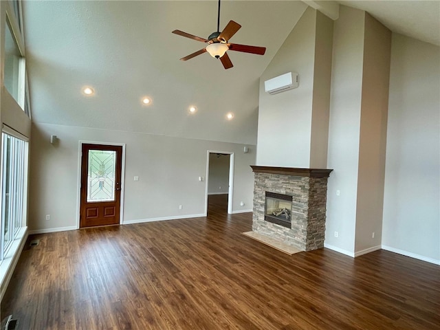 unfurnished living room with high vaulted ceiling, a stone fireplace, ceiling fan, dark hardwood / wood-style floors, and a wall mounted air conditioner