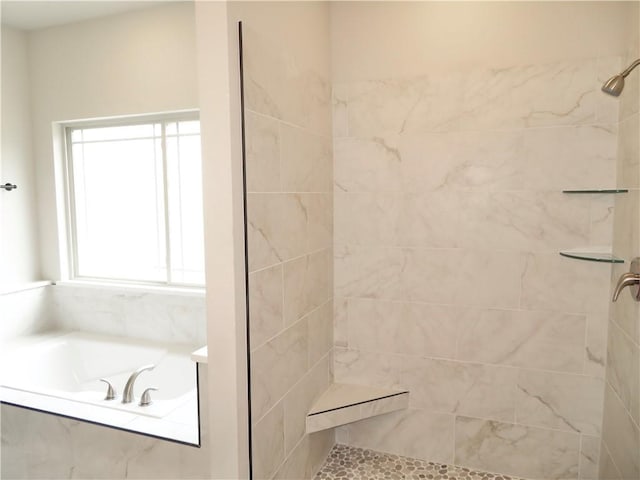 full bathroom with a garden tub and tiled shower