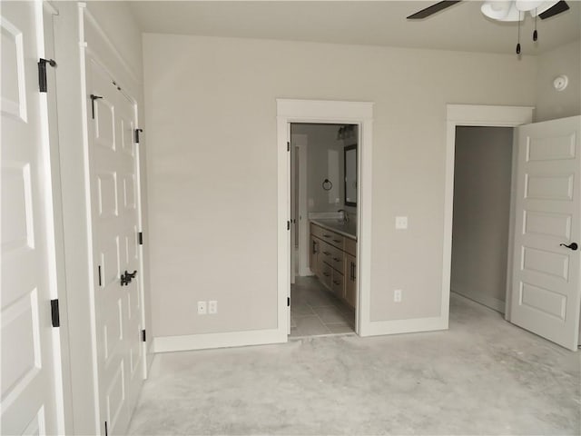 unfurnished bedroom with ensuite bath and baseboards