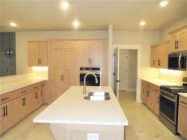 kitchen with marble finish floor, stainless steel appliances, a sink, and light brown cabinetry