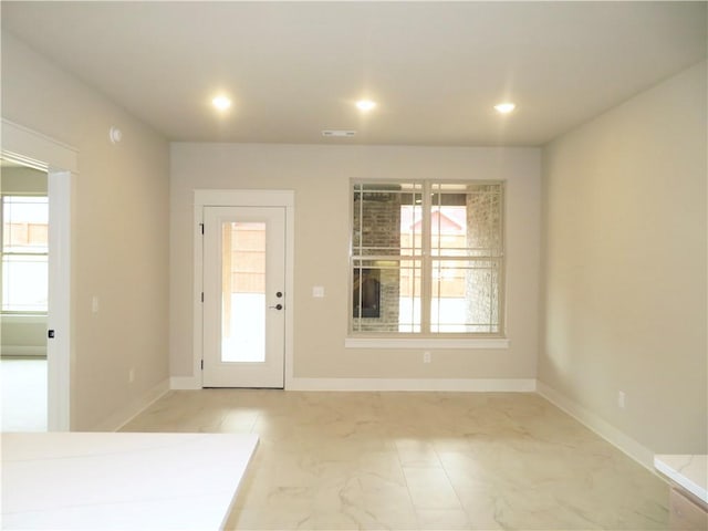 interior space featuring baseboards, visible vents, a wealth of natural light, and recessed lighting