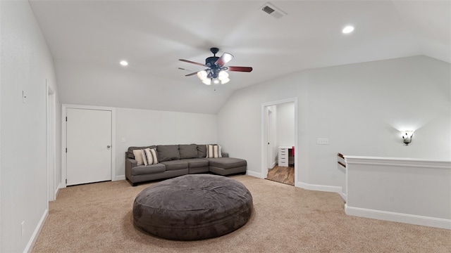 sitting room with lofted ceiling, light colored carpet, and ceiling fan