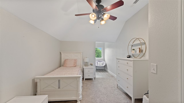 bedroom with light carpet, vaulted ceiling, and ceiling fan