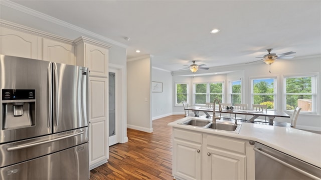 kitchen featuring white cabinetry, appliances with stainless steel finishes, sink, and crown molding