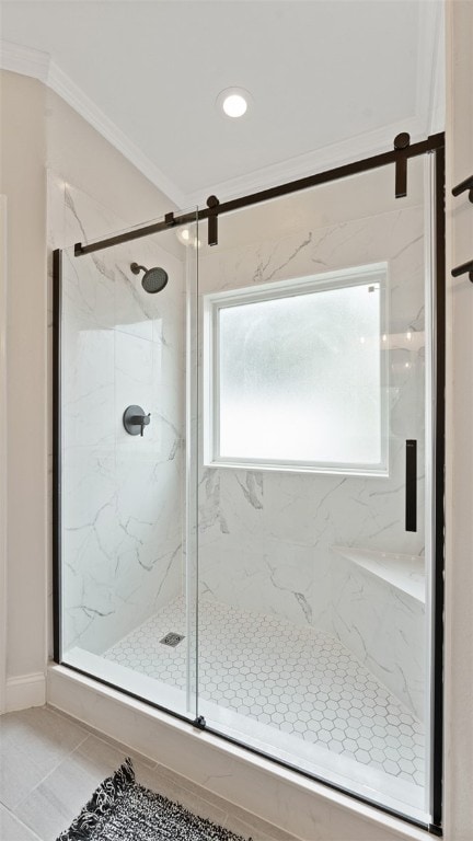 bathroom with tile patterned flooring, a shower with door, and ornamental molding