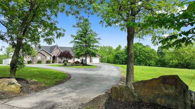 view of front facade with a garage and a front yard