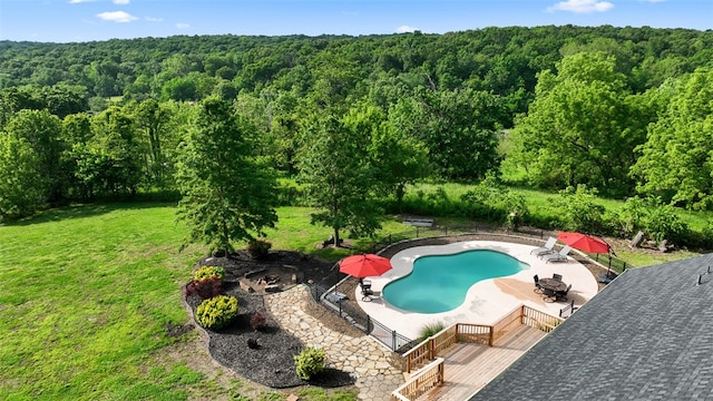 view of pool featuring a patio area, a lawn, and a deck