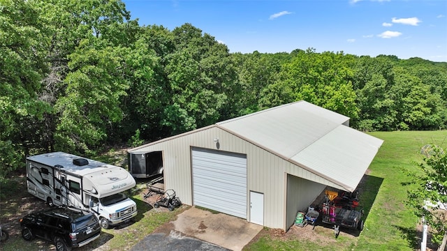 view of outbuilding featuring a garage and a lawn