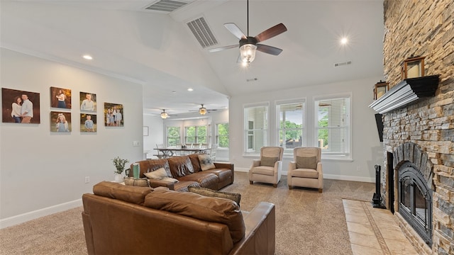 living room featuring ceiling fan, a stone fireplace, and high vaulted ceiling