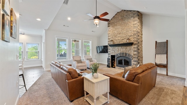 carpeted living room with beamed ceiling, a healthy amount of sunlight, a fireplace, and high vaulted ceiling