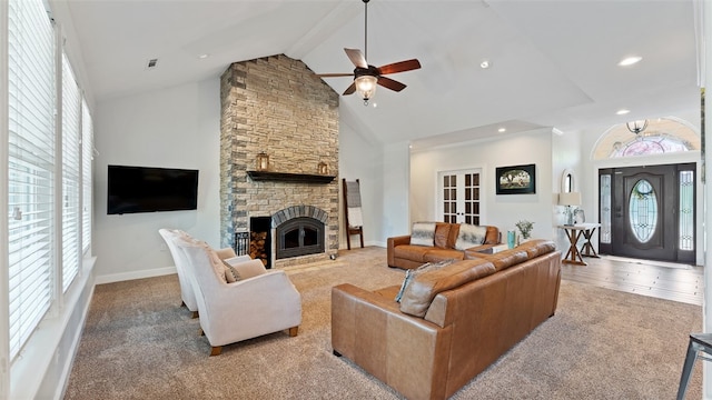 carpeted living room featuring beam ceiling, plenty of natural light, high vaulted ceiling, and a fireplace