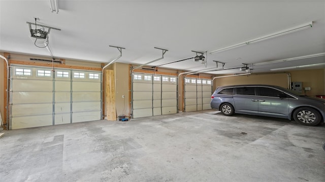 garage featuring a garage door opener and electric panel