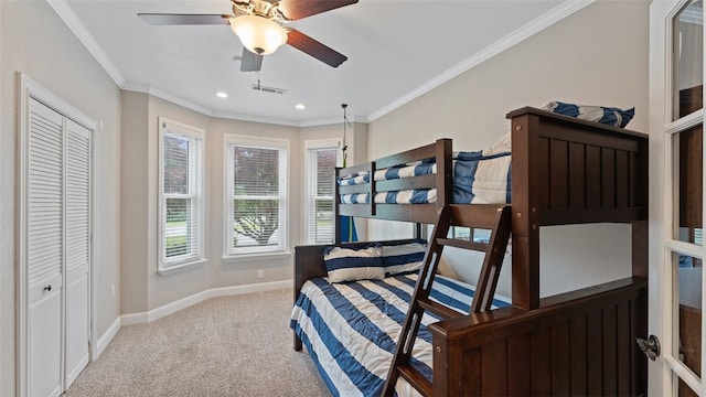 carpeted bedroom featuring crown molding and ceiling fan