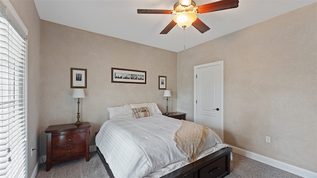 carpeted bedroom featuring ceiling fan and multiple windows