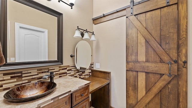 bathroom featuring vanity and decorative backsplash