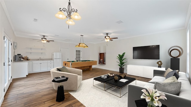 living room featuring crown molding, hardwood / wood-style flooring, billiards, and ceiling fan